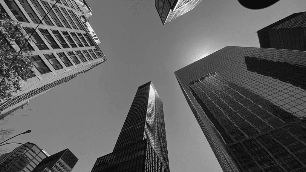 Black and white photo of skyscrapers in new york city.