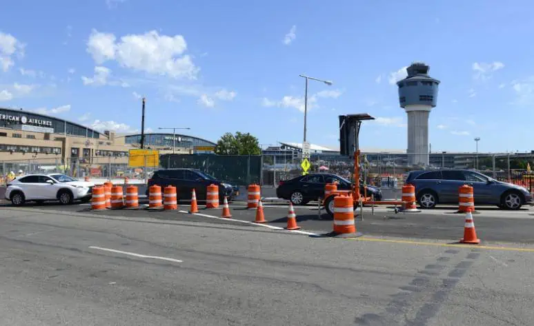 Traffic cones on the side of the road near an airport for Newark Airport Transportation.