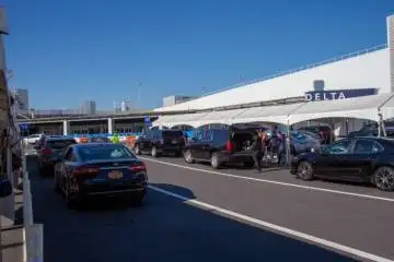 A fleet of cars parked in a parking lot, offering car service to Newark Airport from NJ.