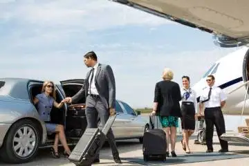 A group of business people boarding a private jet at Trenton airport.