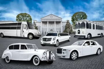 A fleet of white cars and limos parked in front of a mansion, providing upscale airport transportation.