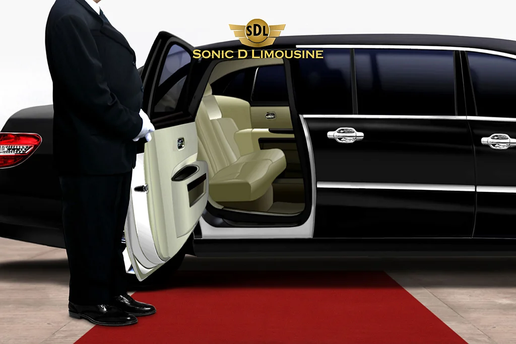 Sonic D Limousine A man standing next to a black limo on a red carpet.